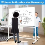 Children drawing on a rolling white board with colorful illustrations in a bright classroom setting